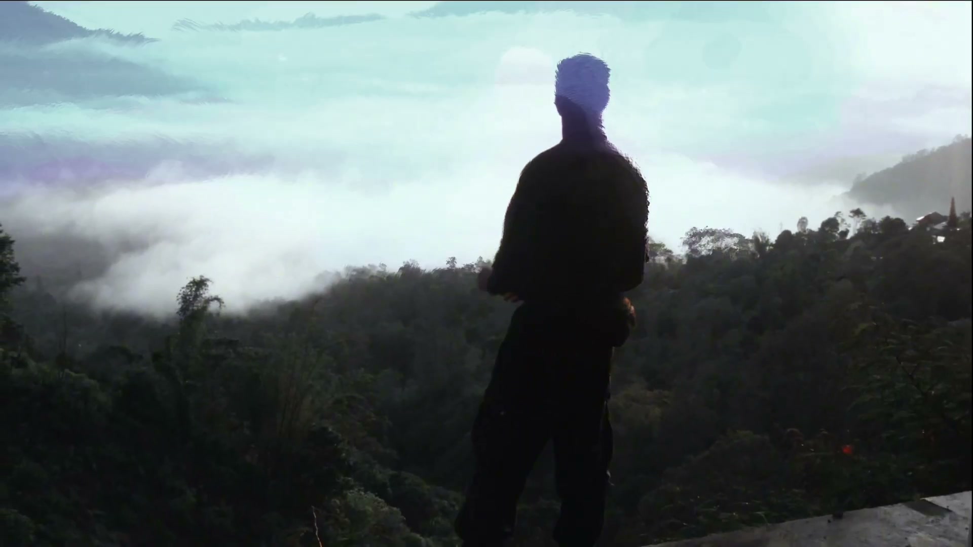 A lone figure silhouetted on a ridge above a mist-filled valley of forested hills, a digital glitch breaking up the sky